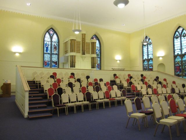 Interior of church facing East with console visible behind raised seating Interior of church facing East with console visible behind raised seating